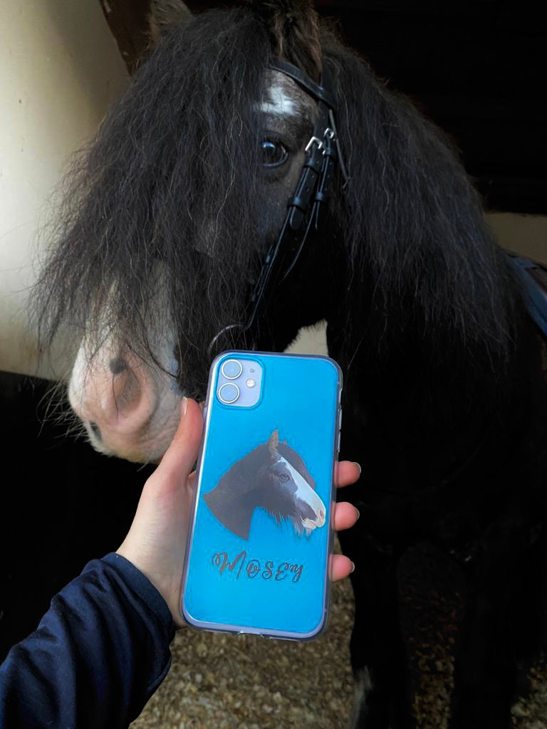 Mosey beside a blue personalised phone case featuring his portrait and name